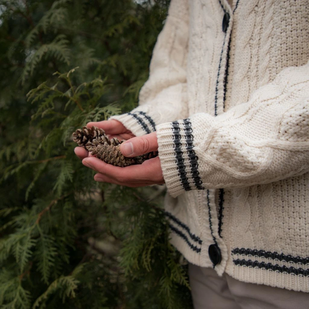 An artisan knitwear studio with undyed wool on a wooden bench